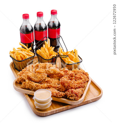 Delicious fried chicken with crispy fries and soft drinks perfect for a casual meal Delicious fried chicken with crispy fries and soft drinks perfect for a casual meal 122672950