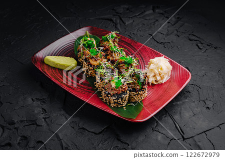 Gourmet sushi rolls topped with fresh ingredients set on a stylish plate Gourmet sushi rolls topped with fresh ingredients set on a stylish plate 122672979
