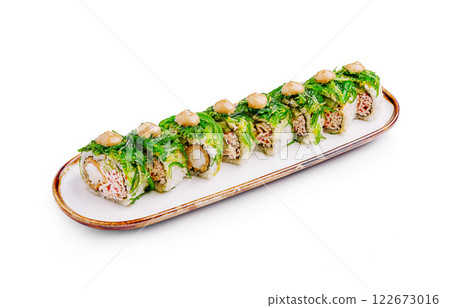 Unique sushi roll presentation featuring fresh ingredients on a white platter Unique sushi roll presentation featuring fresh ingredients on a white platter 122673016