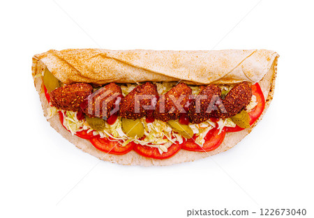 Delicious falafel wrap filled with fresh tomatoes, lettuce, and pickles ready to enjoy on a sunny day Delicious falafel wrap filled with fresh tomatoes, lettuce, and pickles ready to enjoy on a sunny day 122673040