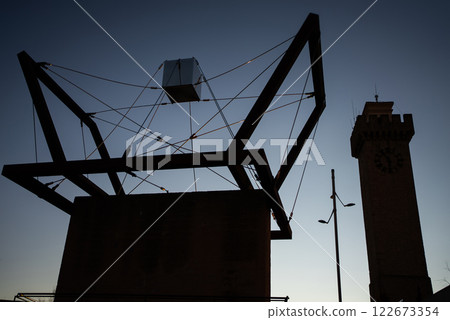 Abstract sculpture in Cuenca against the twilight sky highlighting modern artistry in a historic European town, geometric design Abstract sculpture in Cuenca against the twilight sky highlighting modern artistry in a historic European town, geometric design 122673354