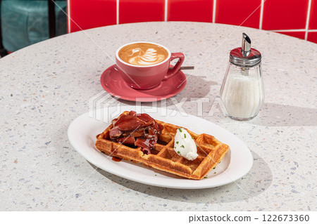 Portion of waffle with brisket and coffee 122673360