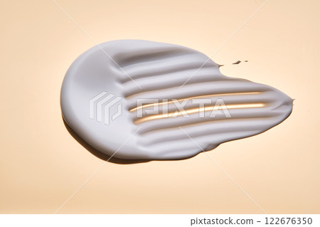 Swatch with white cream texture on a golden background. 122676350