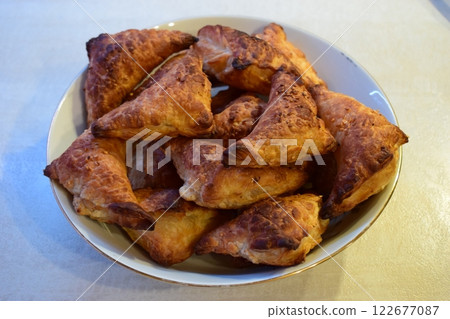 Golden-Brown Triangular Pastries Freshly Baked Golden-Brown Triangular Pastries Freshly Baked 122677087