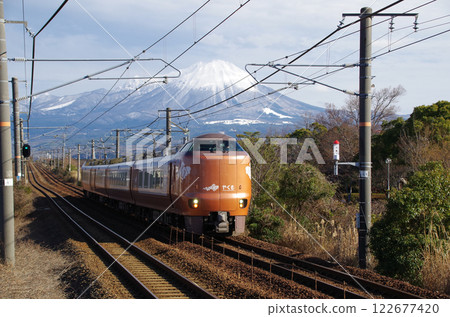 JR Sanin Main Line with the 273 series Yakumo express train running and snow-capped Mt. Oyama 122677420