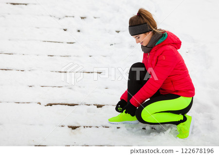 Woman wearing sportswear tying shoes Woman wearing sportswear tying shoes 122678196