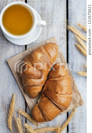 Close-up of croissants on a dark background. Fresh and delicious French pastries, bakery concept, close-up image. tea . 122678621
