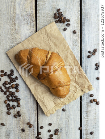 Freshly baked croissants on wooden background Warm Fresh Buttery Croissants and Rolls. food pastry for menu, cafe. 122678937