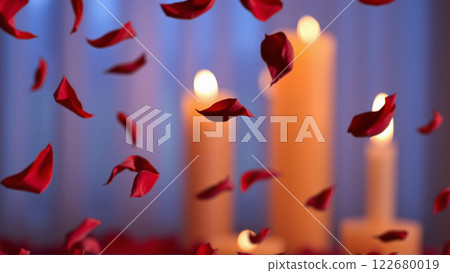 Rose petals falling down against the background of burning candles 122680019