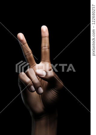 Hand with two fingers raised. Victory, peace sign. Black background. Ai Generative 122680257