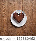 Heart shaped chocolate brownies on a white round plate, wood grain background. AI generated image. 122680462