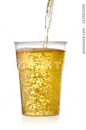 fresh apple juice pouring in to glass 122681069