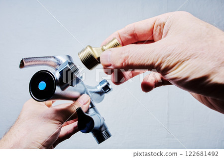 Male tap eccentric reducer being connected to Tub and Shower Faucet Set during installation in bathroom 122681492