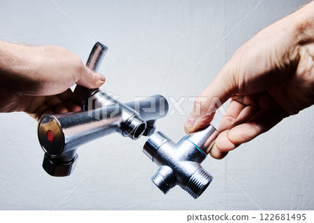 Tub and Shower Faucet Set, showing stainless steel parts being connected during installation in bathroom. 122681495