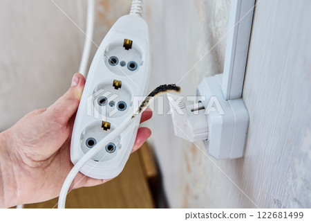 Burnt power cord connected to power strip. 122681499