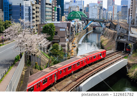 Tokyo Metro Marunouchi Line and cherry blossoms seen from Hijiri Bridge in Chiyoda Ward, Tokyo 122681782