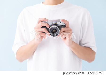 Man holding a film camera (stock photo) 122682759