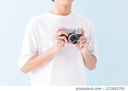 Man holding a film camera (stock photo) 122682762