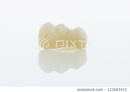 High-quality zirconia dental crown on white background. Dental ceramic crown professional dental lab 122683415