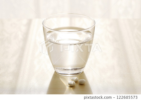 Medicine and water in cup Medicine and water in cup 122685573