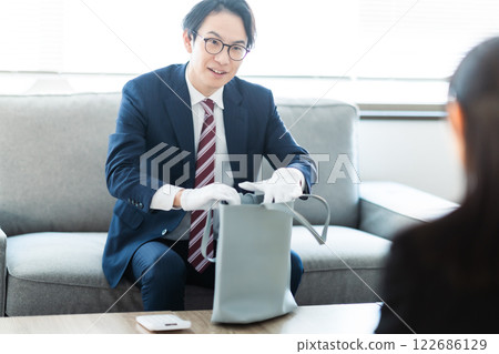 A male businessman visiting a major customer at his home A male businessman visiting a major customer at his home 122686129