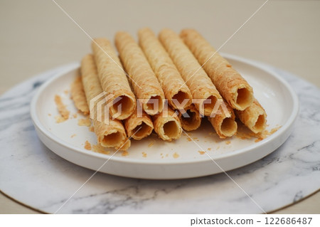 Pile of Cigarette Russe rolled biscuits on white plate Pile of Cigarette Russe rolled biscuits on white plate 122686487