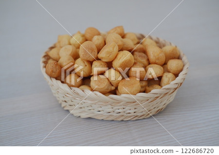 a traditional cake from Indonesia called kue sus filled with cream puffs 122686720