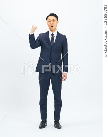 Full-body photo of a middle-aged male business person posing his fist Full-body photo of a middle-aged male business person posing his fist 122686792