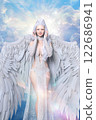 A big-winged angel smiling and holding her hand on her cheek 122686941