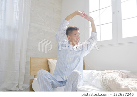 Middle-aged man stretching and waking up 122687246