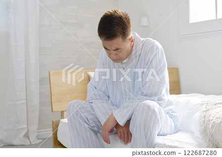 Middle-aged man in pajamas in a daze 122687280
