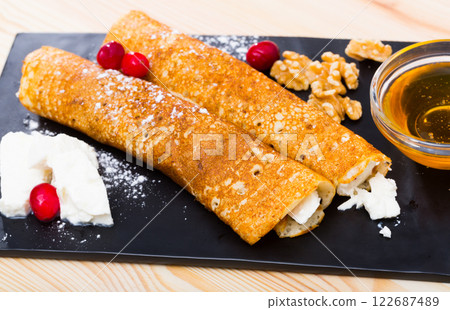 Appetizing pancakes stuffed with cheese 122687489