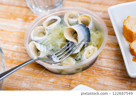 Pieces of pickled herring served with onions Pieces of pickled herring served with onions 122687549