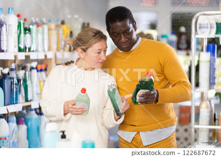 Before buying in household shop, African male customer with European wife choose dishwashing Before buying in household shop, African male customer with European wife choose dishwashing 122687672