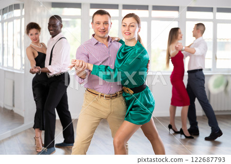 Man and woman dancing waltz in couple during lesson at studio Man and woman dancing waltz in couple during lesson at studio 122687793