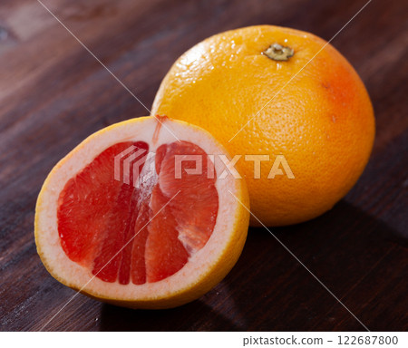 Sliced grapefruit on wooden table Sliced grapefruit on wooden table 122687800