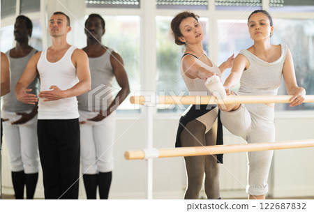 Ballet pose grand batman - ballet troupe of different nationalities at choreography lesson 122687832