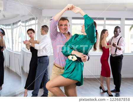 Man and woman dancing waltz in couple during lesson at studio Man and woman dancing waltz in couple during lesson at studio 122687858