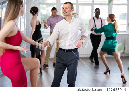 Man and woman practicing swing dance in dancing studio Man and woman practicing swing dance in dancing studio 122687944