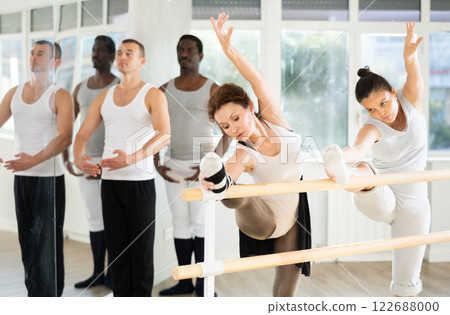 Ballet pose grand batman - ballet troupe of different nationalities at choreography lesson 122688000