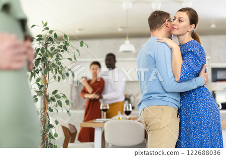 Woman enjoying slow dance with husband at friendly home gathering Woman enjoying slow dance with husband at friendly home gathering 122688036