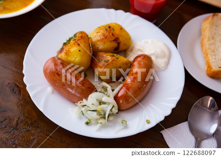 Fried big sausages with potatoes Fried big sausages with potatoes 122688097