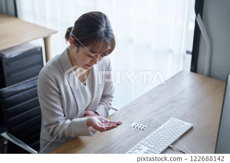 A woman who is taking a medicine with poor physical condition 122688142