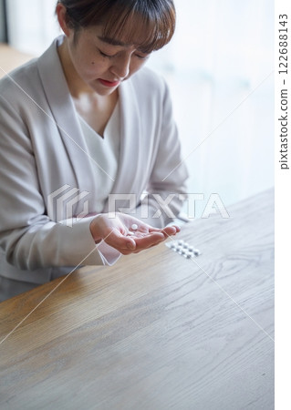 A woman who is taking a medicine with poor physical condition A woman who is taking a medicine with poor physical condition 122688143