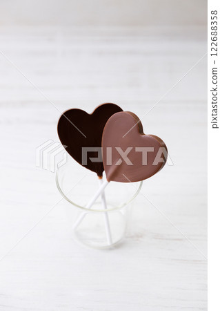 Chocolate hearts on white wooden background, valentines day. 122688358