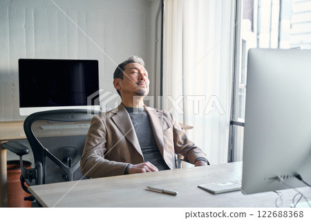 A man who feels sleepy at work A man who feels sleepy at work 122688368
