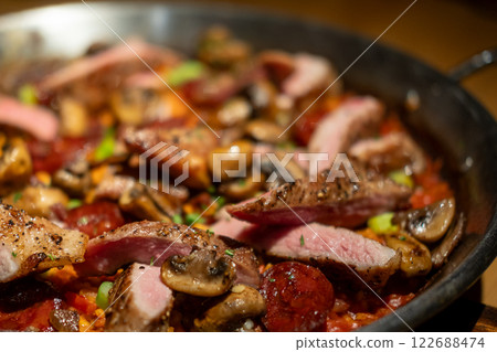 Paella with pork. It is one of the best-known dishes in Spanish cuisine. 122688474