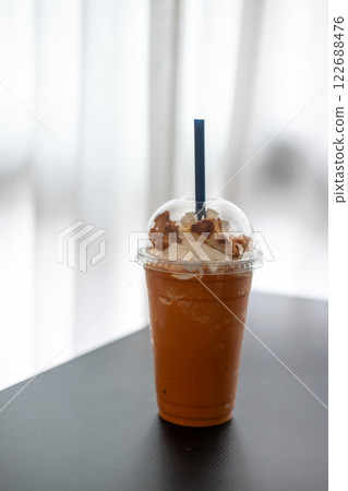 Thai Tea Blended with whipped cream, on the table with blurred background 122688476