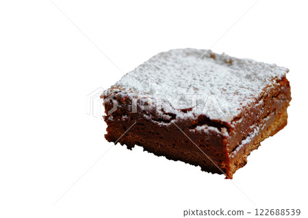 brownie with a dusting of powdered sugar, isolated background brownie with a dusting of powdered sugar, isolated background 122688539