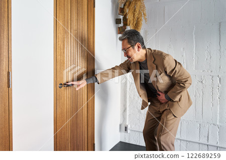 A man who has to defecate and rushes to the toilet A man who has to defecate and rushes to the toilet 122689259